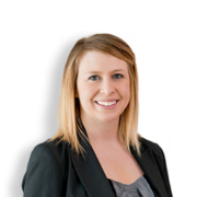 Mallory, a white woman with blond hair, wears a grey blouse and black blazer.