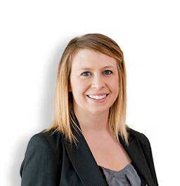 Mallory, a white woman with blond hair, wears a grey blouse and black blazer.