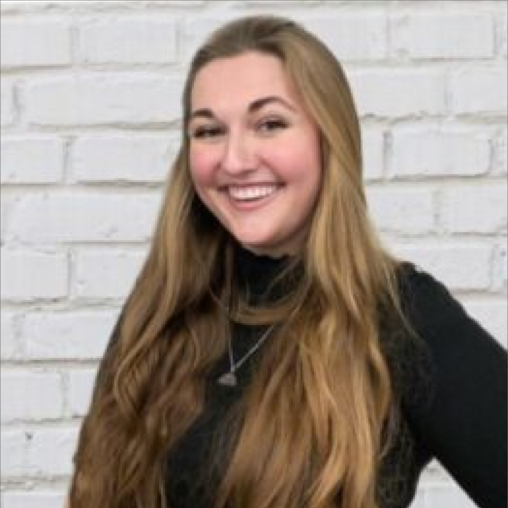 Lauren, a white woman with long brown hair, wears a black turtleneck.
