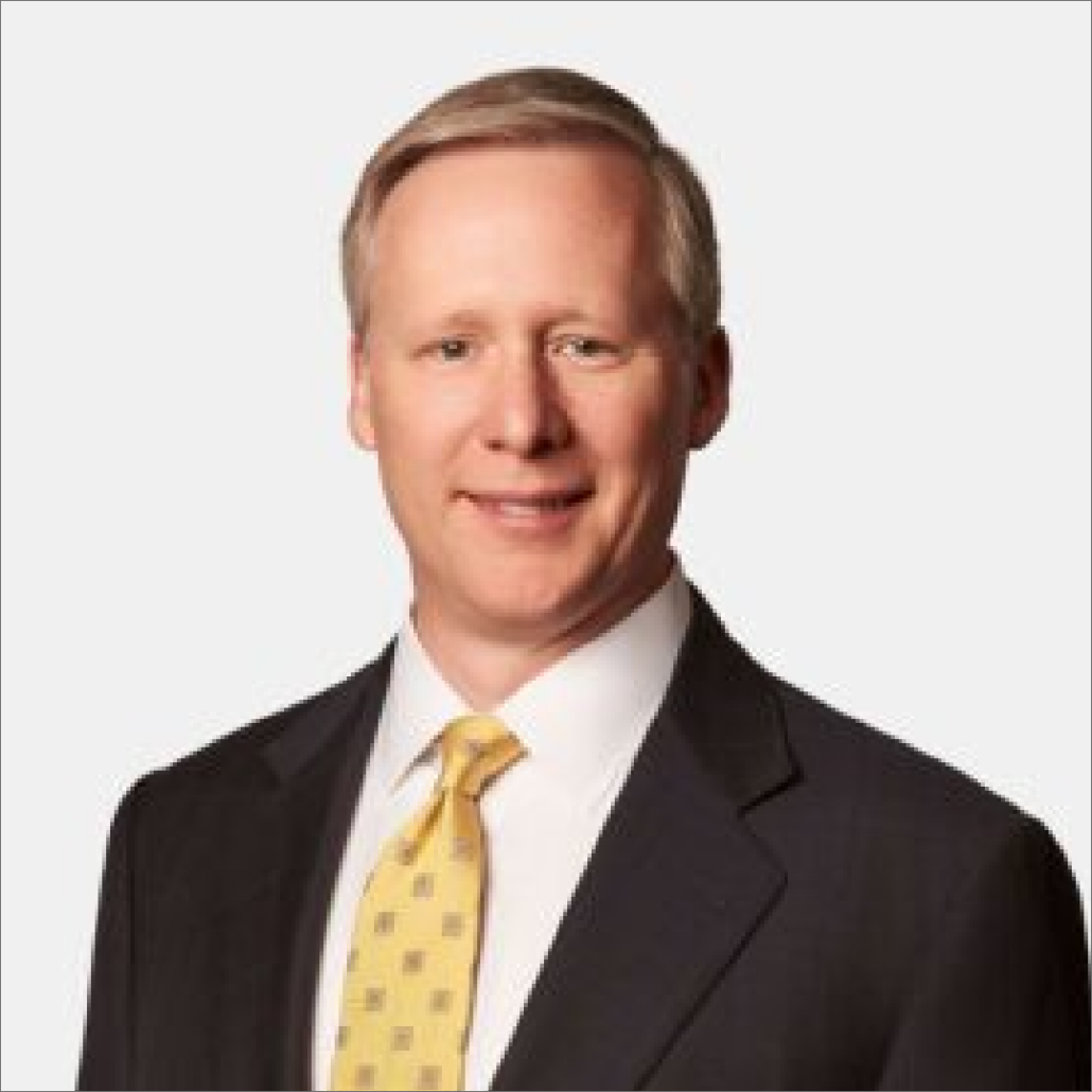 Donald, a white man with blond hair, wears a white shirt, yellow tie with beige squares, and a black suit.