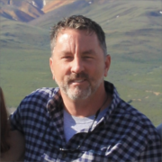 Jeffrey Martin, a white man brown hair and a grey beard, wears a blue and grey plaid shirt.