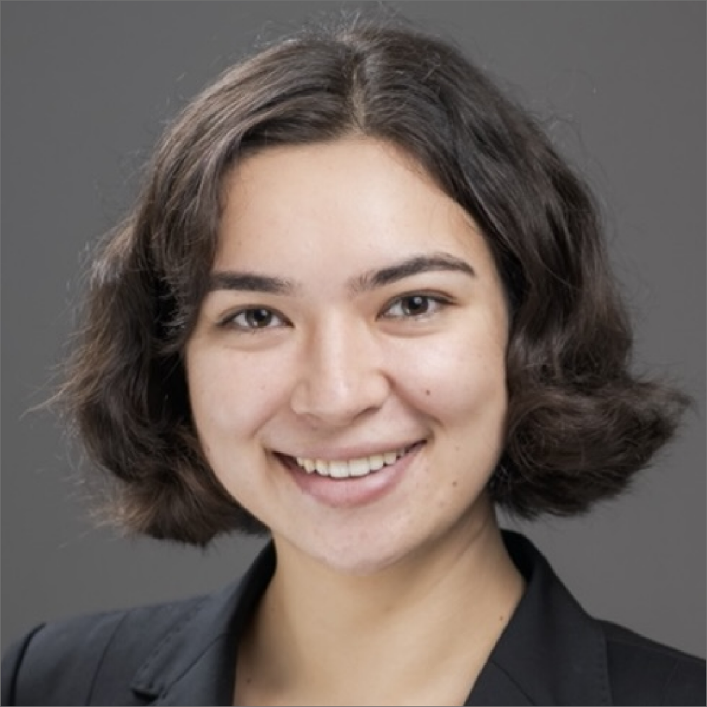Christina, a woman with short, dark brown hair, wears a black suit.