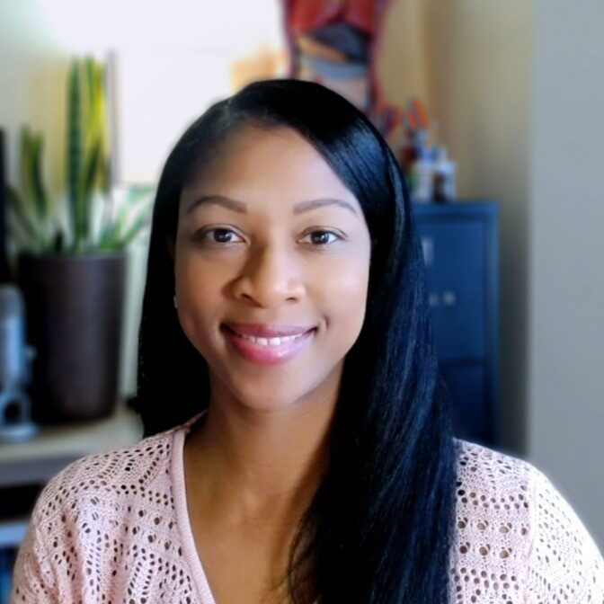 Alicia, a woman with black hair, wears a pale pink sweater. A plant is visible in the background.