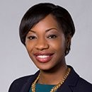 Toni, a Black woman with black hair, wears a teal shirt and black blazer.