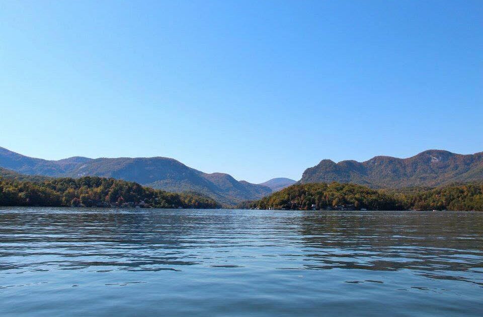 A serene lake is shown with the Blue Ridge Mountains behind it.