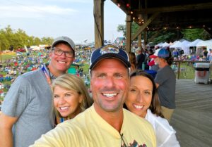 Isley is a white man with brown hair wearing a grey t-shirt, Laura is a white woman with blond hair, Jackson is a white man with brown hair wearing a blue baseball cap and yellow shirt, and Tami is a white woman with brown hair wearing a white shirt.