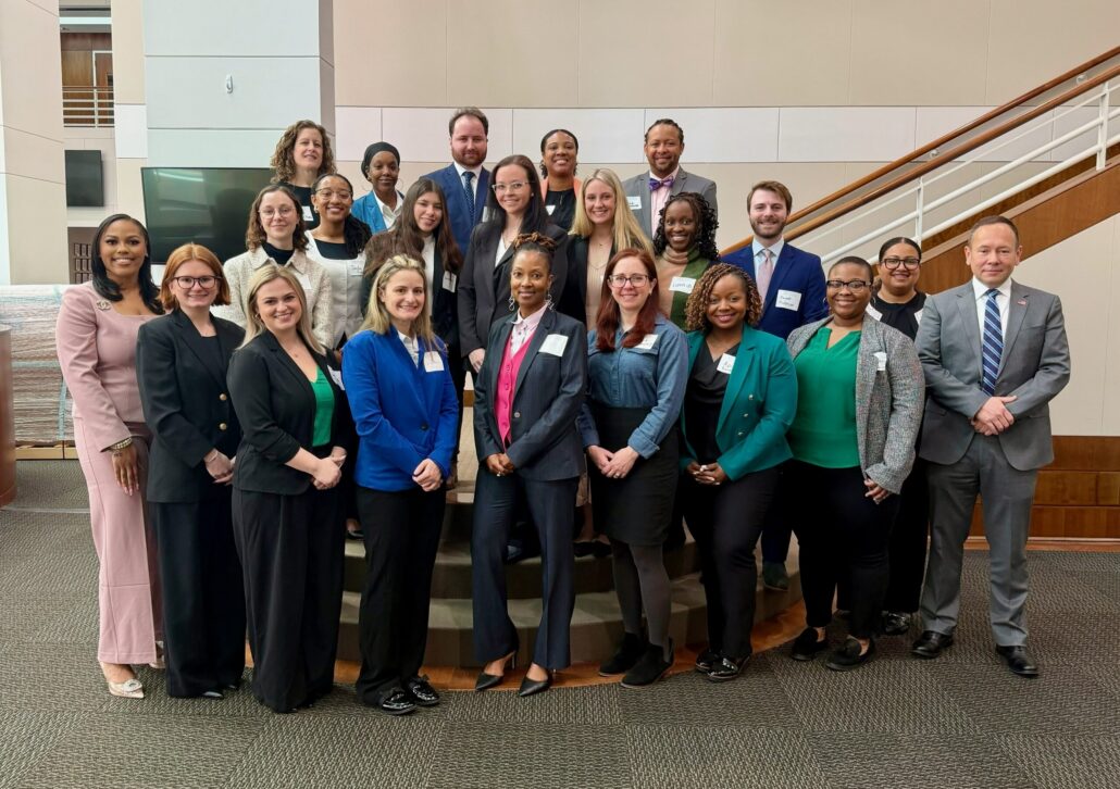 The YLD Pro Bono Cohort is photographed in the lobby of the bar center, along with Sheila Spence and Jason Hensley. 