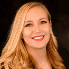 Ashley, a white woman with blond hair, wears a black blouse.
